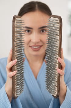 Asian woman holding sadhu boards on face background