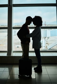 Silhouette, travel and love with couple in airport and hug for departure, flight and say goodbye. Shadow, holiday and sad man and woman leave in embrace by window for journey, international.