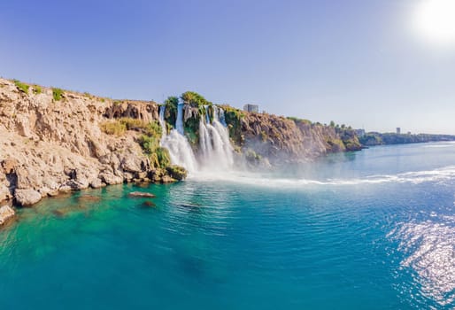 Lower Duden Falls drop off a rocky cliff falling from about 40 m into the Mediterranean Sea in amazing water clouds. Tourism and travel destination photo in Antalya, Turkey. Turkiye