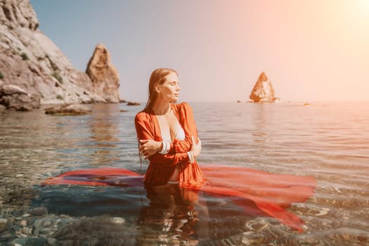 Woman travel sea. Happy tourist taking picture outdoors for memories. Woman traveler looks at the edge of the cliff on the sea bay of mountains, sharing travel adventure journey.