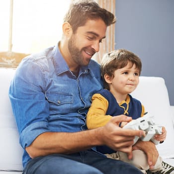 Love, father and son with video game, happiness and gaming at home, loving or smile. Family, male parent or dad with a kid, boy or child with technology, bonding or quality time with games or playing.