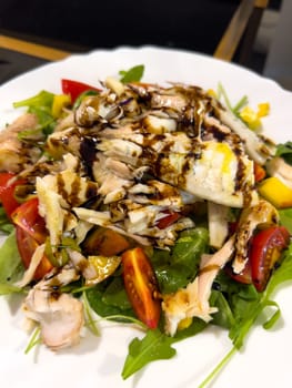 Salad with chicken breast, tomatoes, herbs and soy sauce. High quality photo