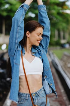 Portrait of a woman brunette smile with teeth walking outside against a backdrop of palm trees in the tropics, summer vacations and outdoor recreation, the carefree lifestyle of a freelance student. High quality photo