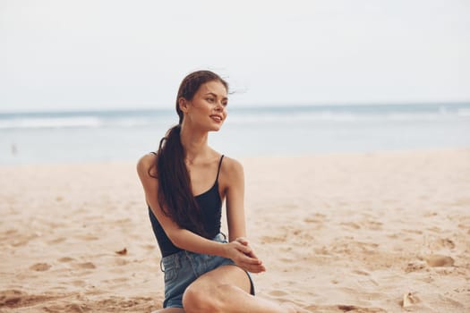 nature woman view beach adult happy beautiful caucasian travel tropical beauty sitting alone freedom water smile outdoor sand sea vacation white back