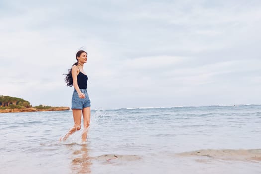 running woman walking sunrise fun long ocean lifestyle young travel sea girl sunset beach summer happiness bikini active wave hair smile sun