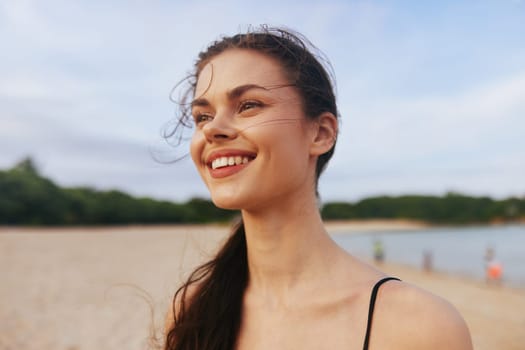 woman smiling dress sand jean beach lifestyle copy-space person walk smile sunset summer ocean travel female sky water vacation sea young