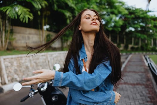 Portrait of a woman brunette smile with teeth running down the street against a backdrop of palm trees in the tropics, summer vacations and outdoor recreation, the carefree lifestyle of a freelance student. High quality photo