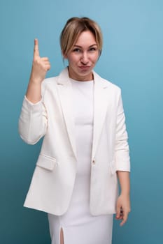 successful young fair-haired business woman in a jacket and dress communicates an interesting idea to a worker.