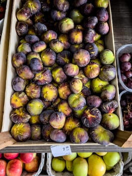 Fresh figs lie in a box on the market. High quality photo