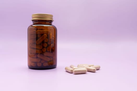 Brown Glass Bottle, Flattered Softgel Capsules OF Slippery Elm On Purple Violet Background, Herbal Supplement, Ulmus Fulva, Natural Remedy. Horizontal plane. Copy Space for Text.