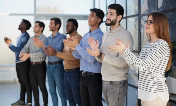 Image of successful business clapping in the office