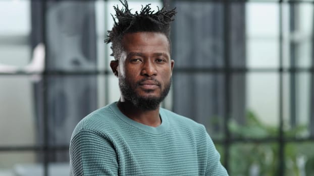 Confident black business man looking at camera with serious expression