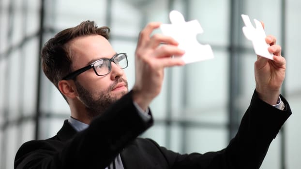 businessman show white jigsaw in hand, business strategy concept
