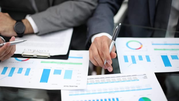 Businessman working at office desk, he is building a growing financial graph using wooden toy blocks. successful business concept