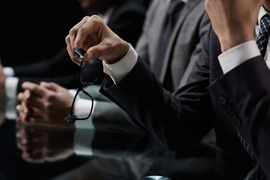 Business partners discuss financial reports, plan an investment strategy. Team of three