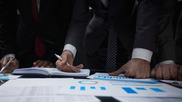 close-up. business colleagues look at the graph on the table from above