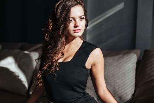 close-up of the seductive face of the brunette with beautiful makeup and sexy lips. luxurious hairstyle and flirtatious look.