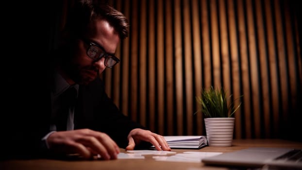 Attractive young guy solves a problem on the table in the office