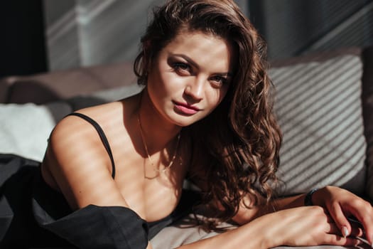 close-up of the seductive face of the brunette with beautiful makeup and sexy lips. luxurious hairstyle and flirtatious look.