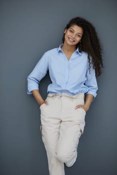Photo of cheerful self-assured lady folded arms wear blue shirt grey color background