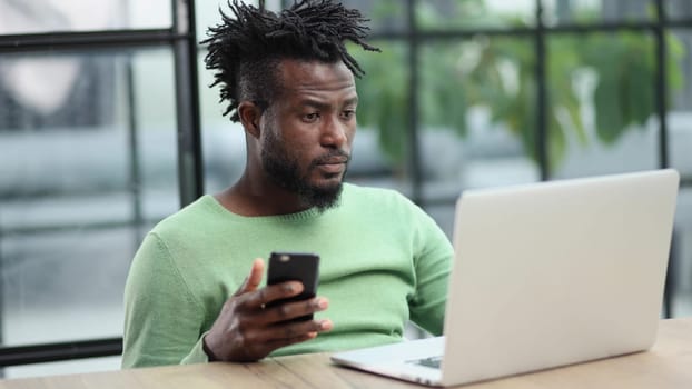 Black businessman talking on cell phone at office
