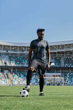 african american man holding a soccer ball in the stadium