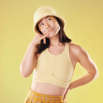Fashion and woman with a hand call isolated on a yellow background in a studio. Idea, thinking and Asian girl with fingers in a telephone gesture for communication, conversation and talking.