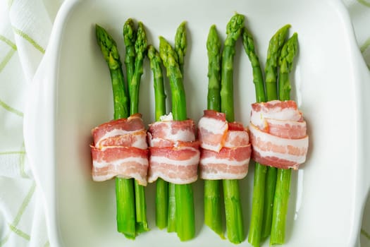 Green asparagus baked with bacon and spices. Very tasty and healthy food. View from above