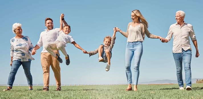 Lift, happy family and summer walk in a field, play and fun in nature together, smile and laugh. Parents, kids and grandparents love enjoying conversation or family time, smile and hold hands outdoor.