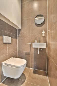 a bathroom with a toilet, sink and mirror on the wall next to each other items in the photo is taken