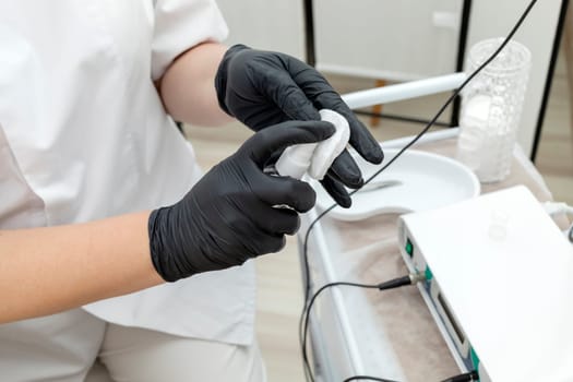 Cropped Electrologist Disinfects Client's Skin Before Hair Removal Procedure With Medical Electrolysis Device In Beauty Salon. Horizontal Plane. Hair Removal Treatment