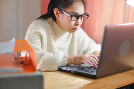 Busy businesswoman working on laptop computer in office. Confident young woman in casual clothes using laptop while working at home.