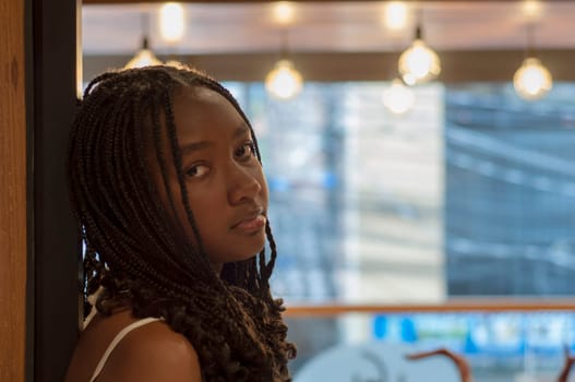 afro teenager with depressed face at a party with copyspace. High quality photo