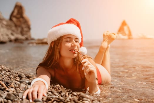 Woman travel sea. Happy tourist taking picture outdoors for memories. Woman traveler looks at the edge of the cliff on the sea bay of mountains, sharing travel adventure journey.