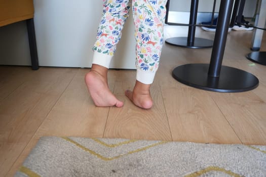 low angle view of A child walking on tiptoes.