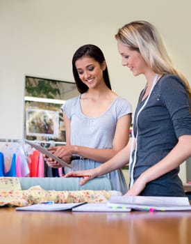 Can we try out this dress pattern. A young fashion designer working with her colleague on a new design