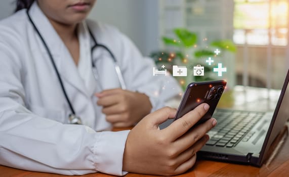 Doctors use smartphones and computers to research medical information. medical concept