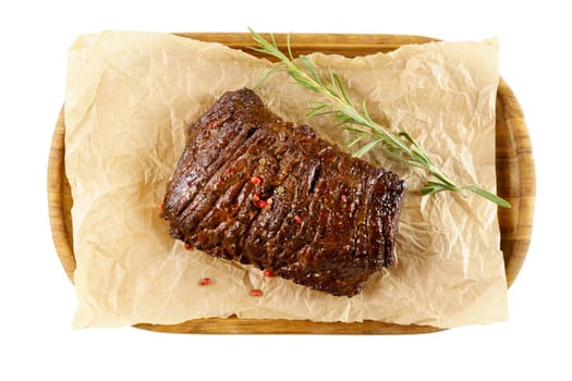 Aged barbecue beef steak close up on wooden background. banner, menu. Isolated on a white background.