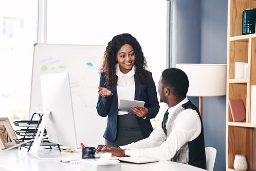 Telemarketing , black people talking and with computer at desk in their office at work with technology. Teamwork or collaboration, internship or communication and African coworkers discussing.