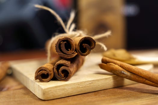 Cinnamon sticks on wooden background close-up, macro. Selective focus