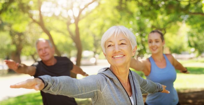 Yoga, fitness and an old couple with their personal trainer in a park for a health or active lifestyle. Exercise, wellness or zen and senior people outdoor for a workout with their pilates coach.
