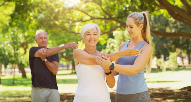 Yoga, exercise and an old couple with their personal trainer in a park for a health or active lifestyle. Fitness, wellness or zen and senior people outdoor for a workout with their pilates coach.