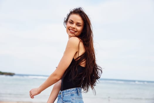 sand woman long tropical carefree running ocean bag smile relax sea caucasian summer nature beach beauty freedom beautiful hair vacation young adult