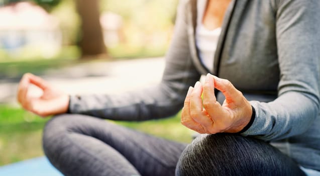 Woman in park, yoga and meditation with lotus pose, fitness outdoor with zen and spiritual healing. Female person hand, exercise in nature and meditate for health with wellness and mindfulness.