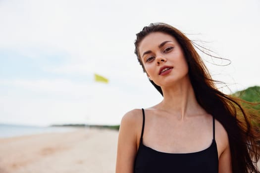 woman ocean copy female nature long space carefree hair sea freedom summer bag beach girl walk sunlight smile vacation enjoyment beautiful sand young