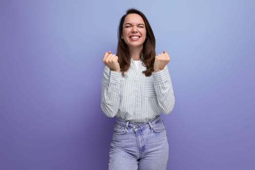 joyful lucky 25 year old brown-haired woman on purple background.