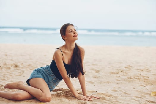 back woman summer beach sand travel sitting alone natural sea outdoor pretty girl carefree freedom view sun nature hair smile long vacation relax