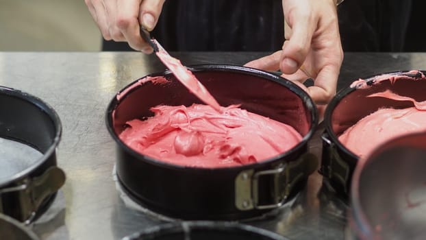 chef preparing white pink red cake creamy mixtures doughs to bake in the oven