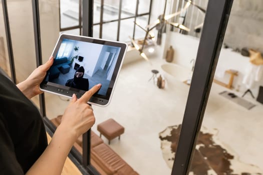 Woman monitoring modern cctv cameras on laptop indoors, closeup. Home security system.