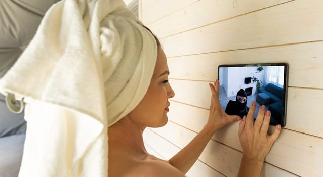 Woman monitoring modern cctv cameras on laptop indoors, closeup. Home security system.